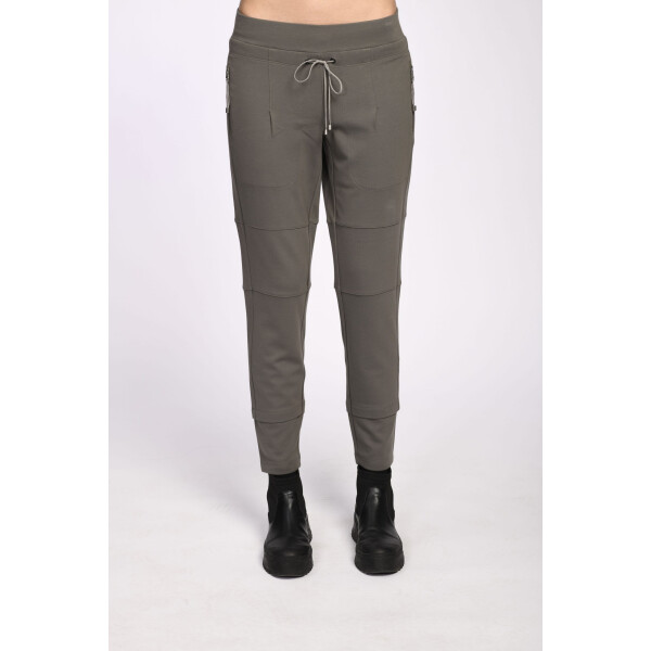 Person wearing khaki green trousers with zipper