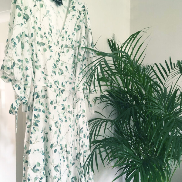 Lagom Anna Botanical Print Linen Wrap Dress in white with green leaf print is a very feminine drop hem tiered dress with sleeves, available on top UK stockist colmershill.com