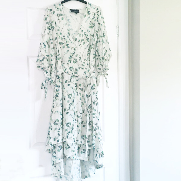 Lagom Anna Botanical Print Linen Wrap Dress in white with green leaf print is a very feminine drop hem tiered dress with sleeves, available on top UK stockist colmershill.com