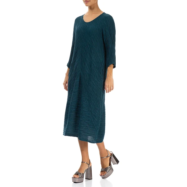 Grizas crinkled dress in dark teal is made of silk and linen. It has a slightly balloon shaping which is very flattering to many shapes and sizes. Available on Colmershill.com, UK stockist of Grizas