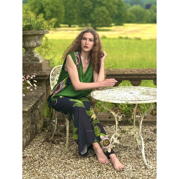 From My Mother's Garden Palazzo Trousers in the Passionflower print on a black background, made of a draping crepe fabric