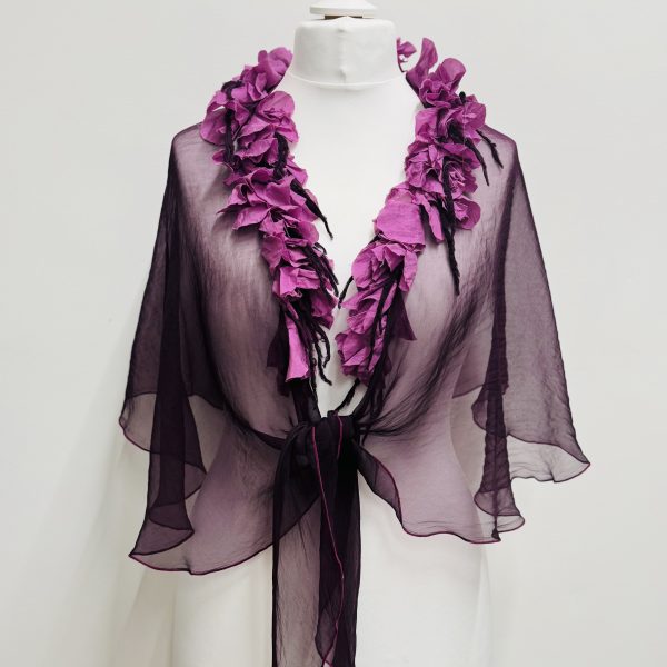 Out of Xile Silk Organza Cape in various colours. They have silk flower embellishments around the neckline