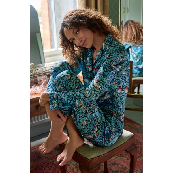 Hope & Ivy Maggie Satin Pyjamas in William Morris Bird print with blue piping and matching fabric bag.