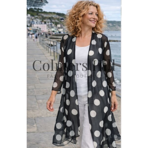 Kozan Maris Mesh Jacket Dalmatian SH-2855 black sheer longline jacket with ivory spot print worn with white trousers and top