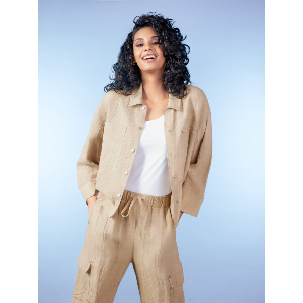 A versatile layering piece for warmer seasons, the Alison Sheri Linen Shacket in Sand combines the structure of a jacket with the ease of a shirt