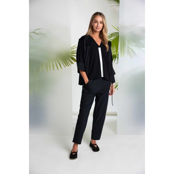 The Naya Pull Up Slim Leg Trouser with Patch Pocket Black (NAS26109) is a sleek, versatile staple from Naya Clothing, designed to deliver comfort without compromising on contemporary style