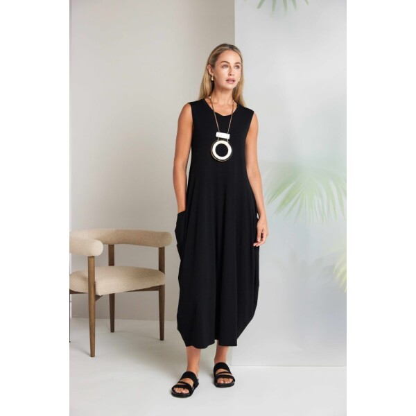A signature silhouette from Naya Clothing, the Naya Round Neck Sleeveless Dress With Side Pockets reflects the clean lines and contemporary feel associated with modern