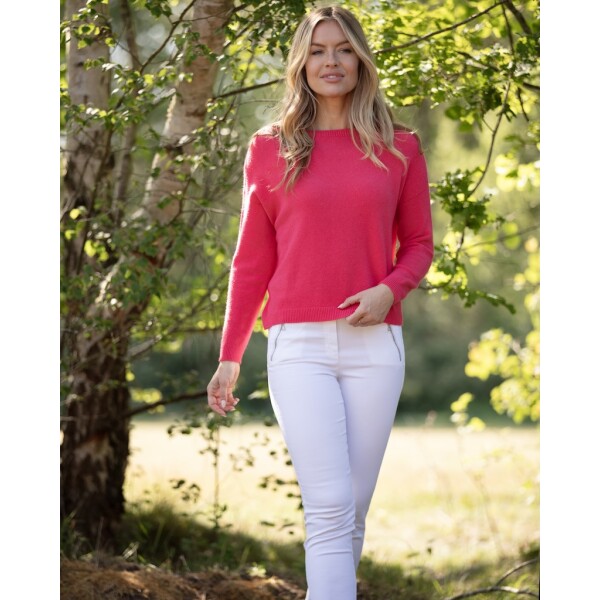 From My Mother’s Garden Teaberry knit jumper styled with white jeans outdoors